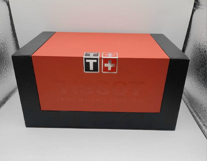 Tissot PR100 watch with box and papers, featuring a stainless steel band and classic dial design.