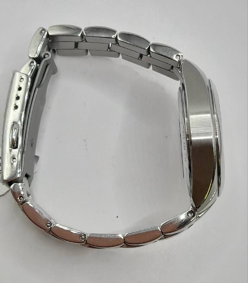 Tissot PR100 watch with box and papers, featuring a stainless steel bracelet and classic dial design.