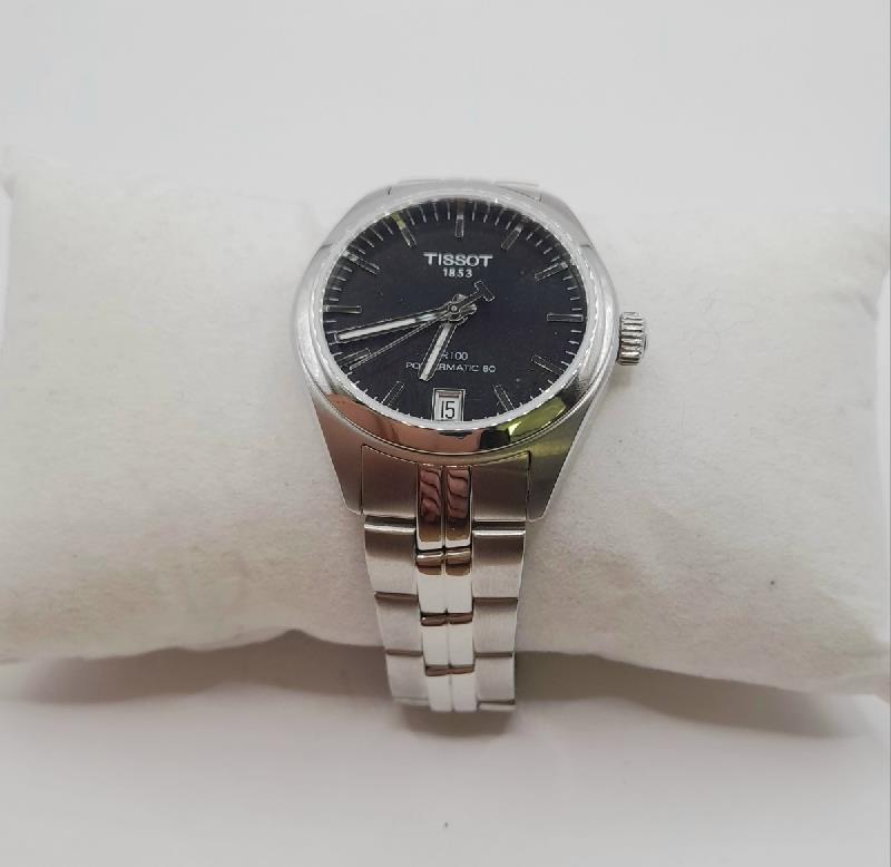 Tissot PR100 wristwatch with box and papers, featuring a sleek dial and stainless steel band.