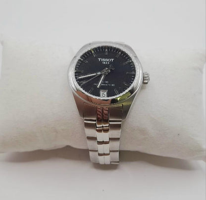Tissot PR100 wristwatch with box and papers, featuring a sleek dial and stainless steel band.