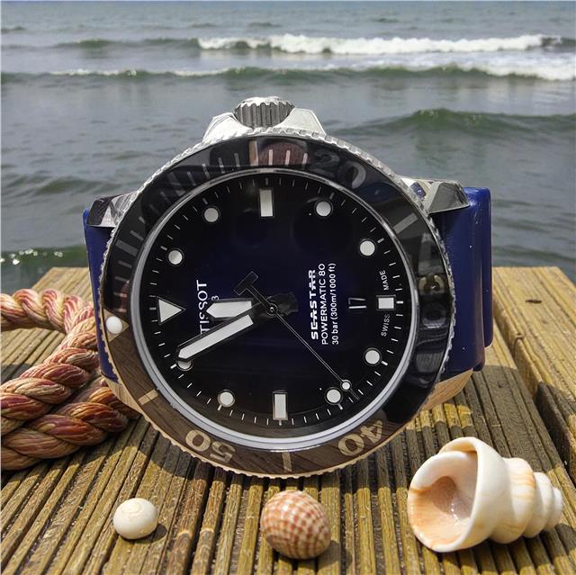 Tissot Seastar Power Matic 80 watch with box and papers, showcasing the stainless steel case and black dial.