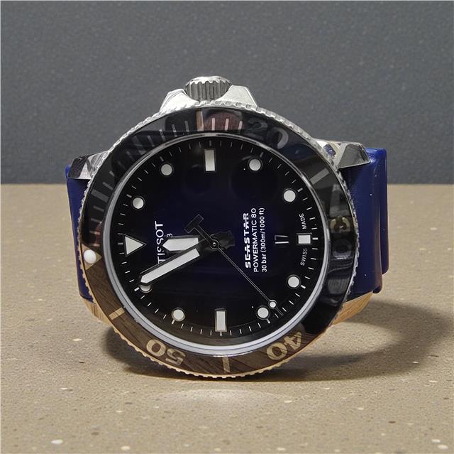 Tissot Seastar Power Matic 80 watch with boxed papers, featuring a stainless steel case and black dial.