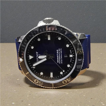 Tissot Seastar Power Matic 80 watch with boxed papers, featuring a stainless steel case and black dial.