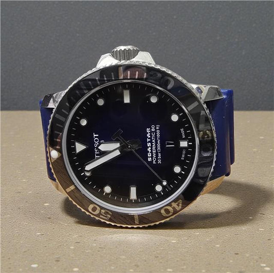 Tissot Seastar Power Matic 80 watch with boxed papers, featuring a stainless steel case and black dial.