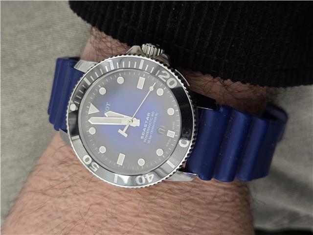 Tissot Seastar Power Matic 80 watch with boxed papers, featuring a stainless steel case and black dial.