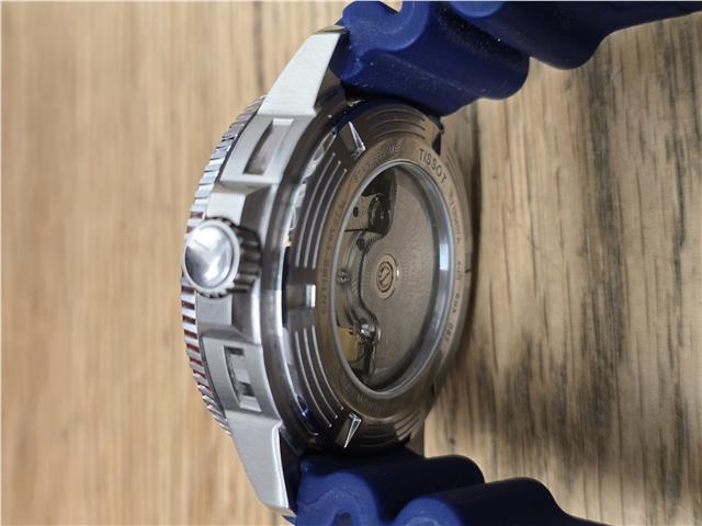 Tissot Seastar Power Matic 80 watch with box and papers, featuring a stainless steel case and black dial.