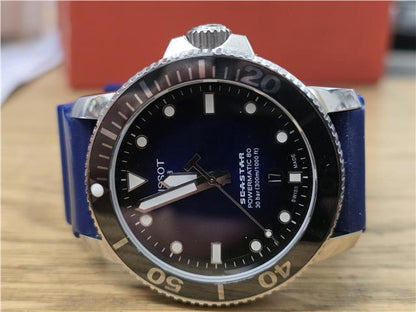 Tissot Seastar Power Matic 80 watch with boxed papers, featuring a stainless steel case and black dial.