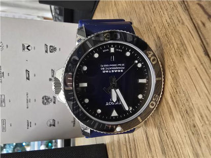Tissot Seastar Power Matic 80 watch with box and papers, featuring a stainless steel case and black dial.