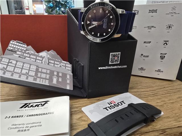 Tissot Seastar Power Matic 80 watch with boxed papers, featuring a stainless steel case and black dial.