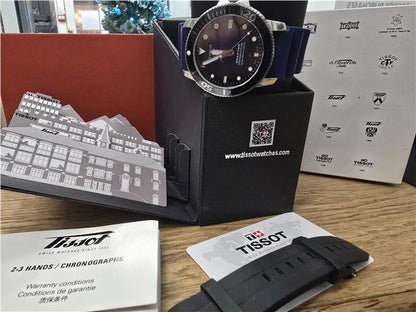 Tissot Seastar Power Matic 80 watch with boxed papers, featuring a stainless steel case and black dial.
