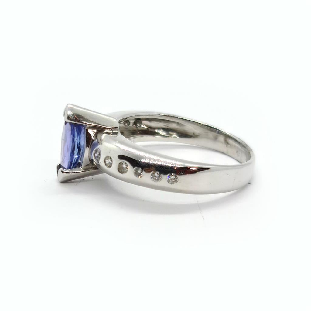 14ct gold ring featuring 0.85 carats of Tanzanite and diamond accents, elegant jewelry piece with a polished band