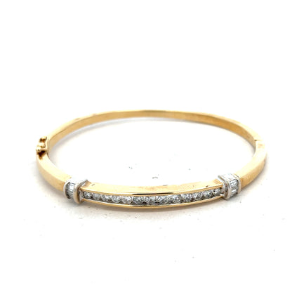 14ct yellow gold diamond bangle with 1 carat total weight, featuring sparkling diamonds and a sleek, elegant design.