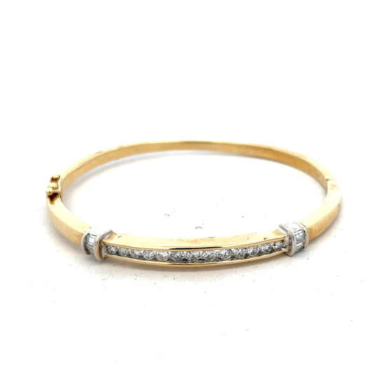 14ct yellow gold diamond bangle with 1 carat total weight, featuring sparkling diamonds and a sleek, elegant design.