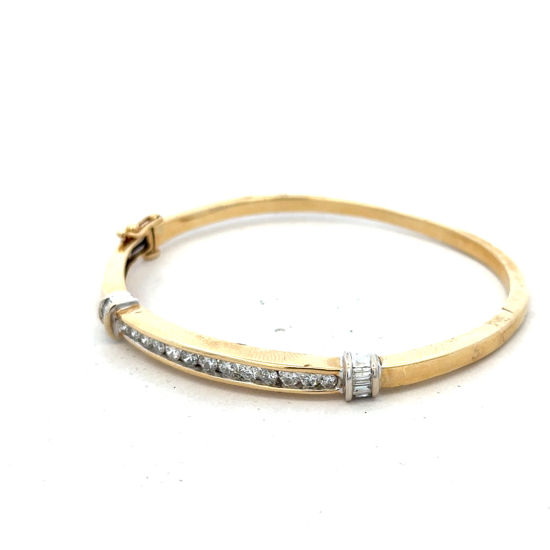 14ct yellow gold diamond bangle with 1 carat total weight, featuring sparkling diamonds and a sleek, elegant design.