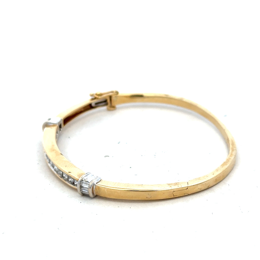 14ct yellow gold diamond bangle with 1 carat total weight, featuring sparkling diamonds and a sleek design.