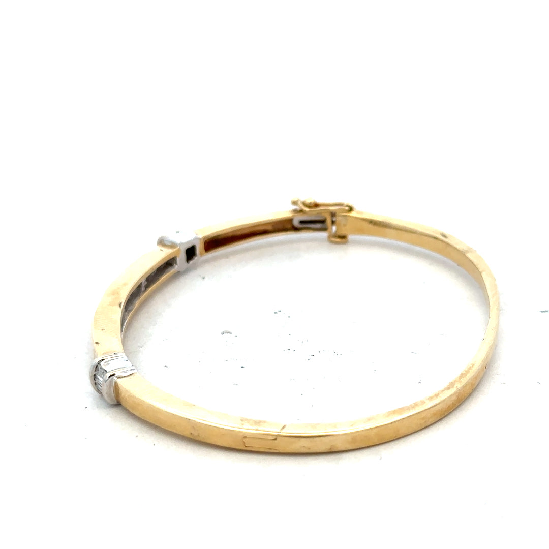14ct yellow gold diamond bangle with 1 carat total weight, featuring sparkling diamonds and a sleek, elegant design.