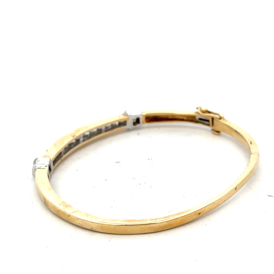 14ct yellow gold diamond bangle with 1 carat total weight, featuring sparkling diamonds and a sleek gold design.