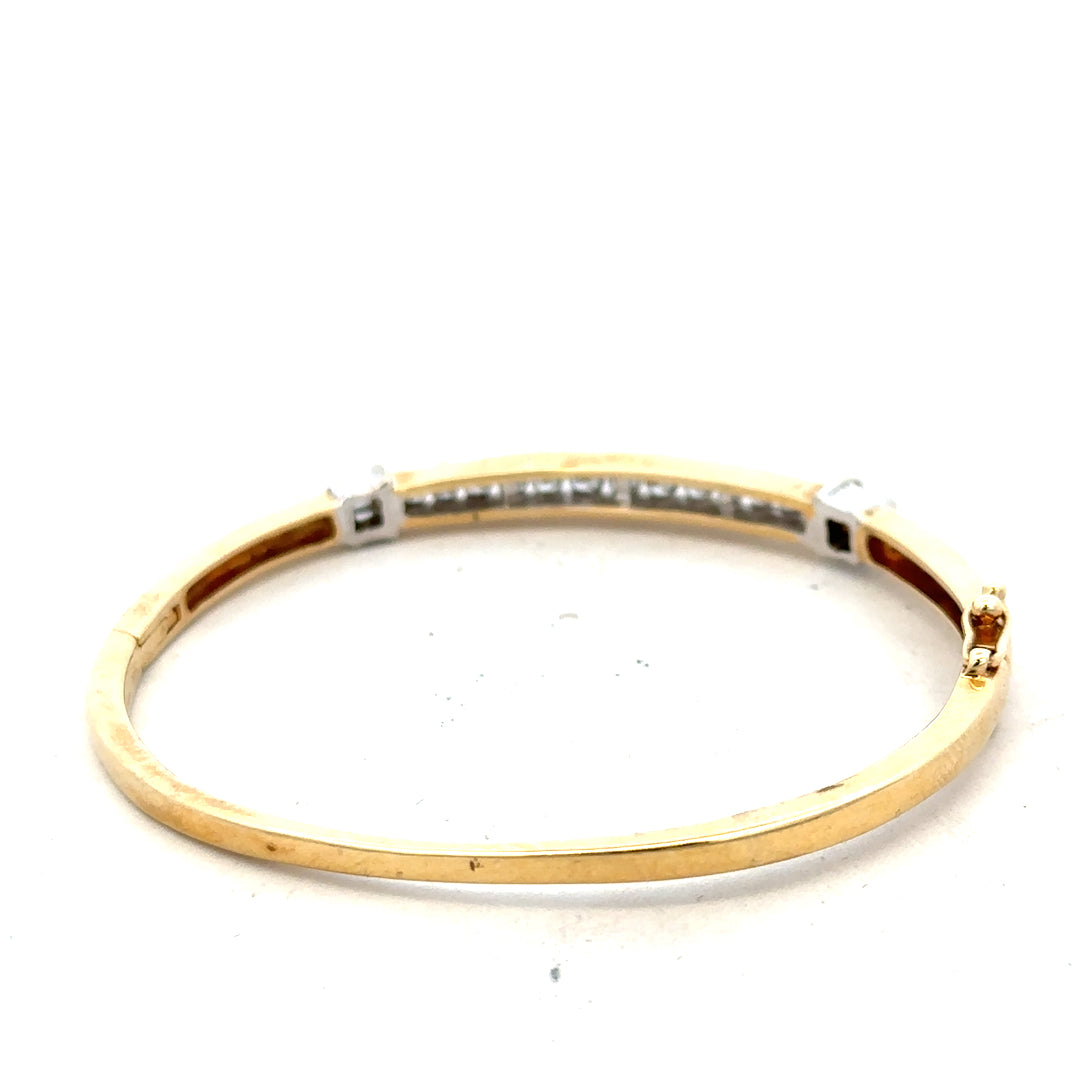 14ct yellow gold diamond bangle with 1 carat total weight, featuring sparkling diamonds and a sleek design.