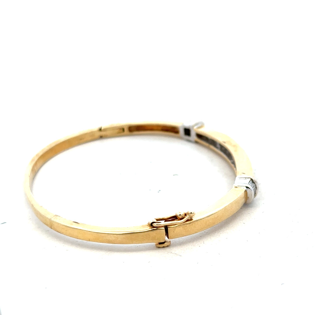 14ct yellow gold diamond bangle with 1 carat total weight, featuring sparkling diamonds and a sleek design.