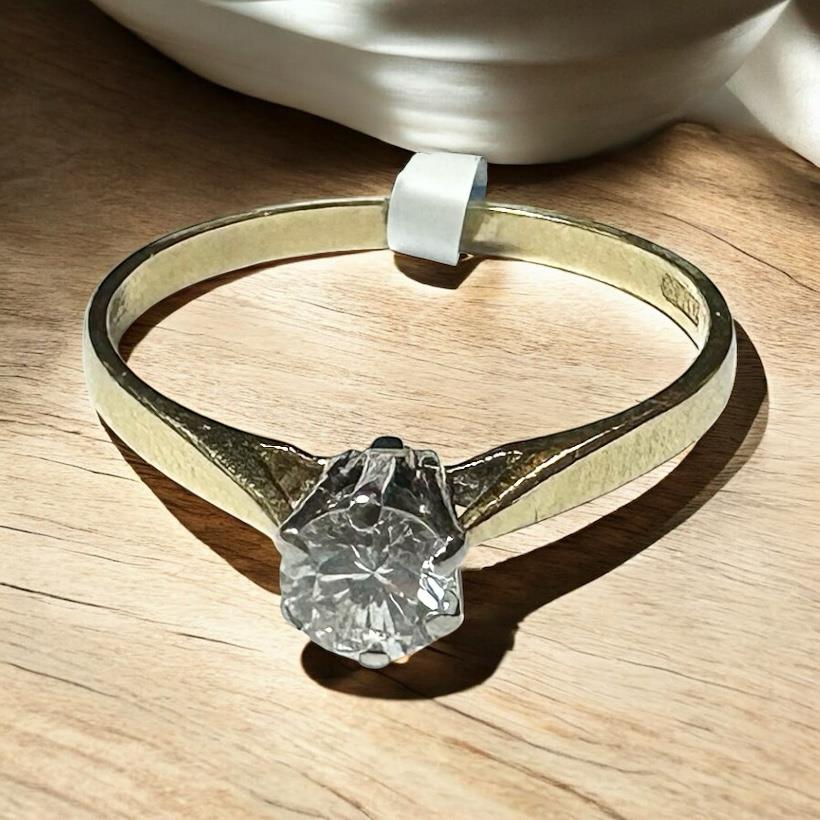 14ct yellow gold diamond ring in size P, featuring a sparkling diamond and classic design, unbranded.
