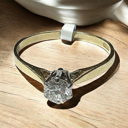 14ct yellow gold diamond ring in size P, featuring a sparkling diamond and classic design, unbranded.