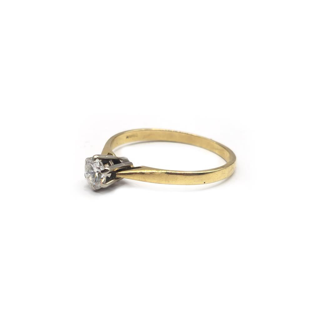 14ct yellow gold diamond ring, size P, featuring a sparkling diamond, seen on a plain background.