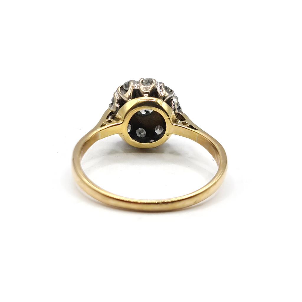 18ct gold diamond cluster ring with 0.55 carats of sparkling diamonds, featuring a detailed, elegant design.