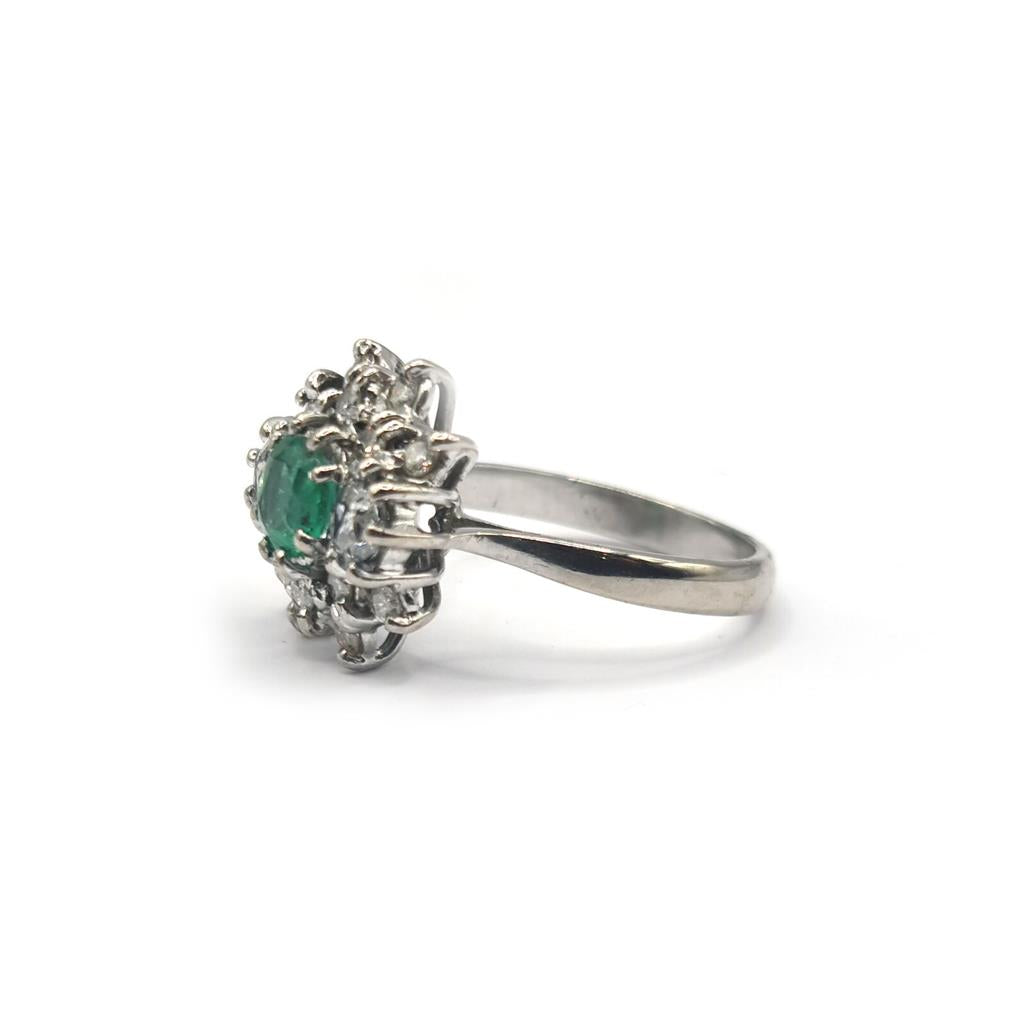 18ct gold ring featuring a 0.65 carat emerald and 1.15 carat diamond, showcasing a elegant gemstone design.