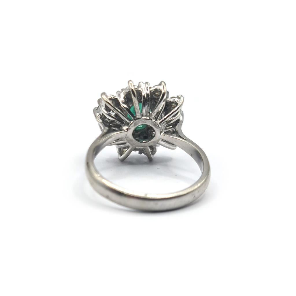 18ct gold ring featuring a 0.65 carat emerald and 1.15 carat diamond, set in a elegant jewelry design.