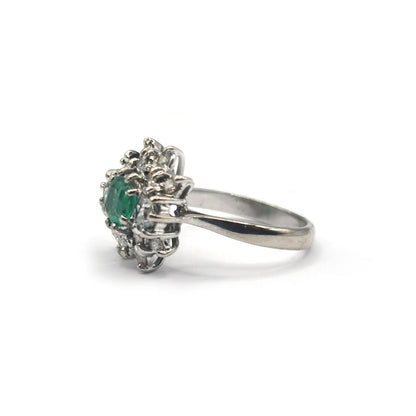 Elegant 18ct gold ring featuring a 0.65ct emerald and 1.15ct diamond, showcasing intricate design and sparkling gemstones.