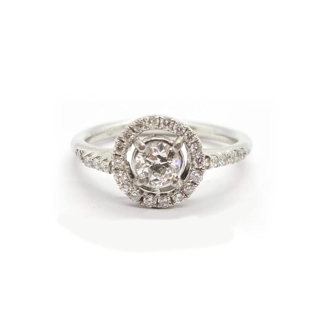 18ct gold diamond halo ring with 0.80ct center stone and surrounding smaller diamonds, elegant jewelry piece.