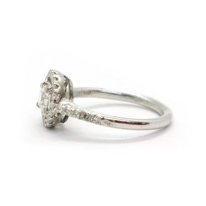 18ct gold diamond halo ring with 0.80ct total weight featuring sparkling diamonds and a classic design.