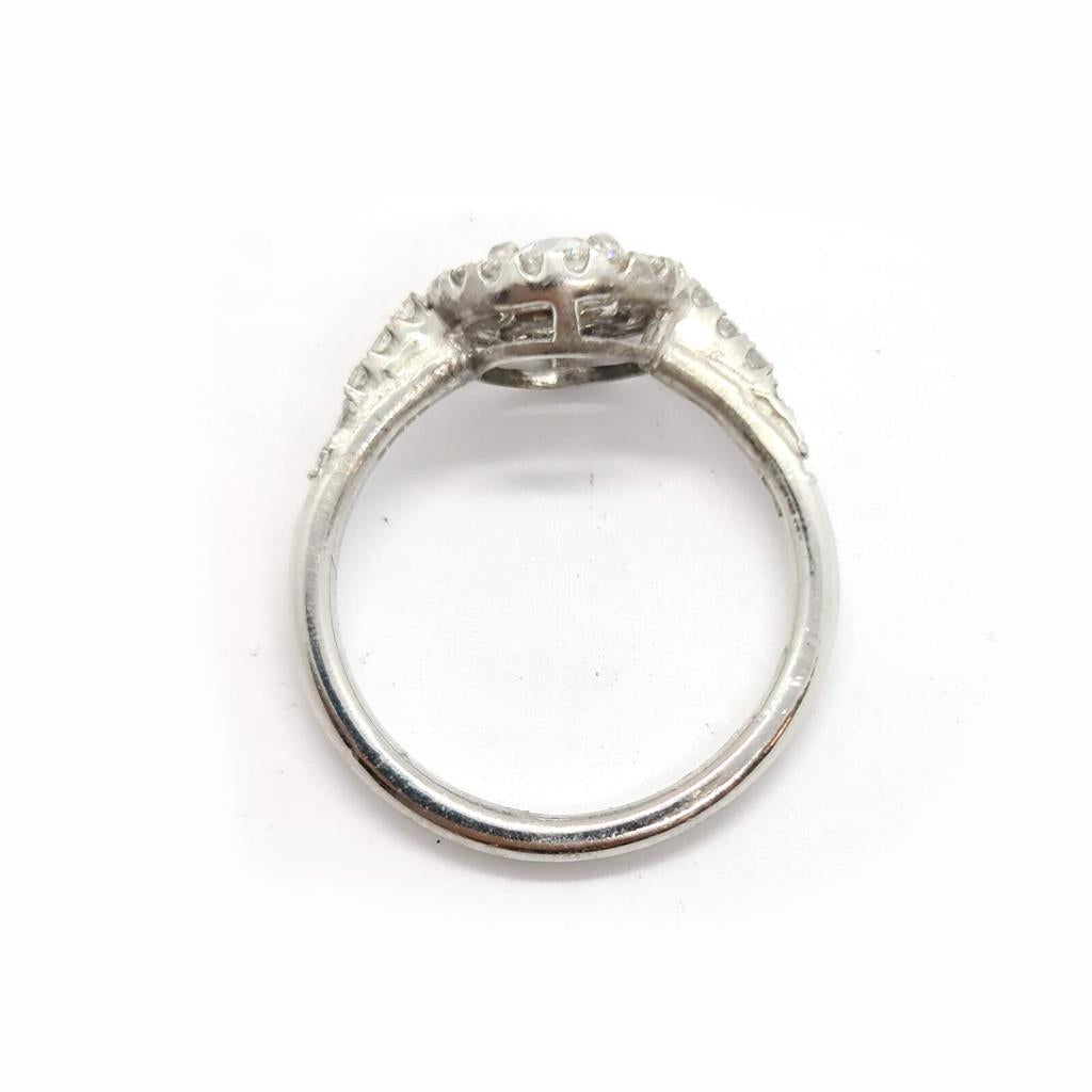 18ct gold diamond halo ring with 0.80ct center stone and intricate halo design, featuring sparkling diamonds and a elegant band.