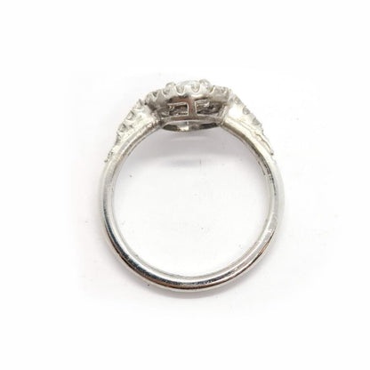 18ct gold diamond halo ring with 0.80ct center stone and intricate halo design, featuring sparkling diamonds and a elegant band.