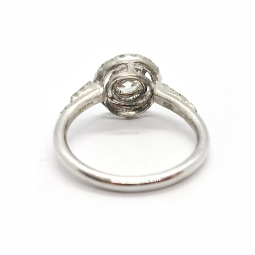 18ct gold diamond halo ring with 0.80ct sparkling central diamond and intricate halo setting.