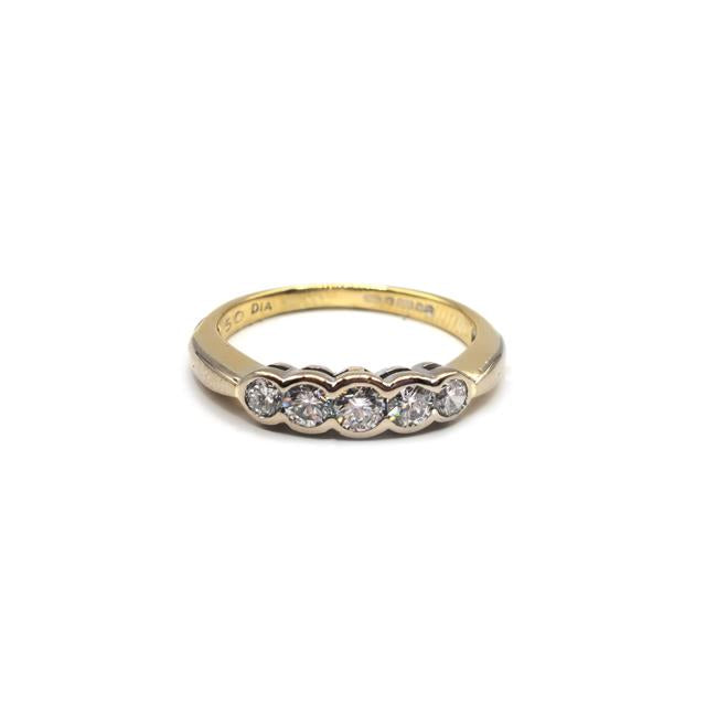 Elegant 18ct diamond ring with sparkling stones set in a classic design, showcasing fine craftsmanship and brilliance.