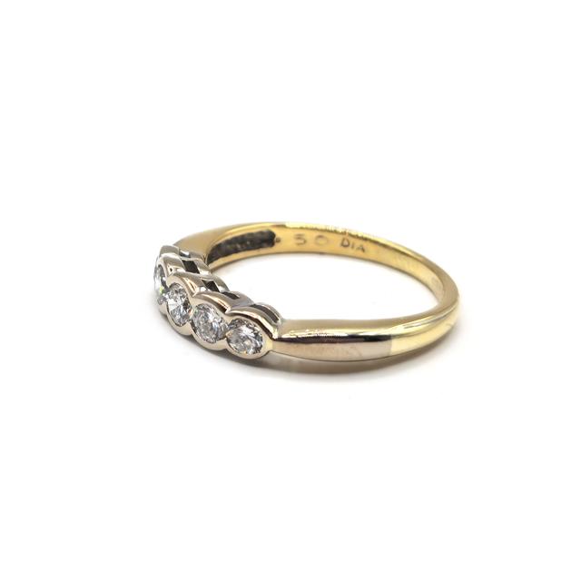 Elegant 18ct diamond ring with sparkling stones set in a classic band, unbranded jewelry piece.
