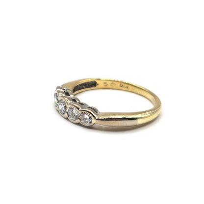 Elegant 18ct diamond ring with sparkling stones set in a classic band, unbranded jewelry piece.