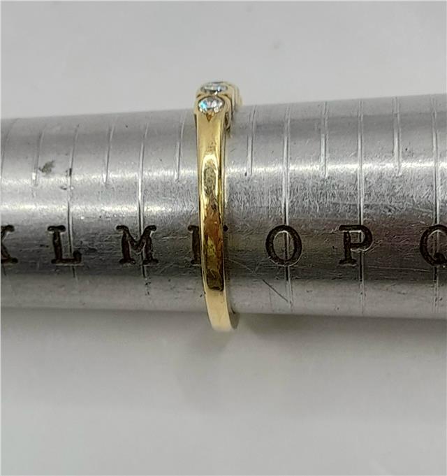 18ct diamond ring in size N featuring a sparkling diamond band, unbranded jewelry piece with elegant design.