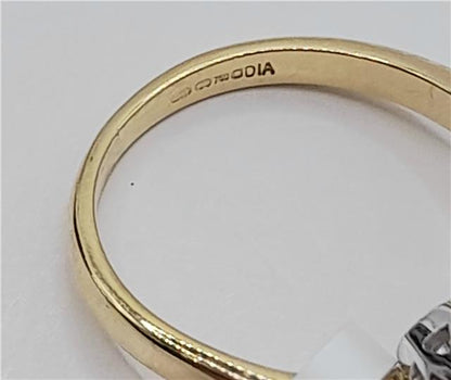 18ct gold diamond ring with 0.75ct stones in size L, featuring elegant design and sparkling diamonds on a gold band.