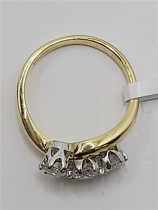 18ct gold diamond ring with 0.75 carats, size L, featuring a sparkling central gemstone and elegant gold band.