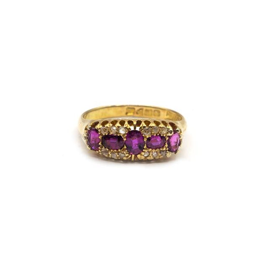 18ct ruby and diamond ring featuring a central ruby gemstone surrounded by sparkling diamonds, set in a sleek band.