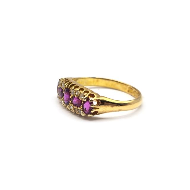 18ct ruby and diamond ring featuring a vibrant red ruby center stone surrounded by sparkling diamonds.