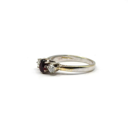 18ct white gold ring featuring a 0.24 carat diamond and 0.45 carat garnet gemstone, elegant jewelry piece.