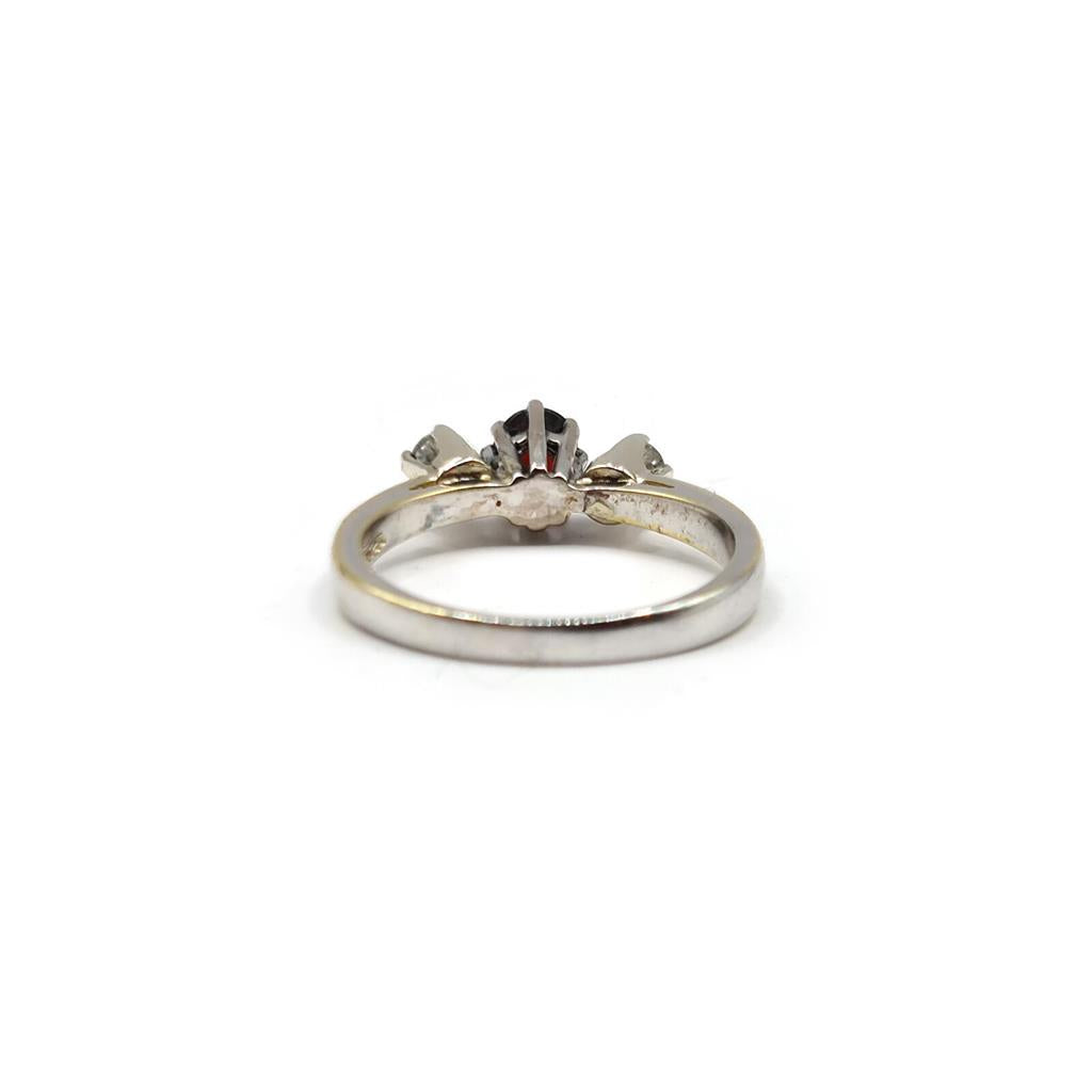 18ct white gold ring featuring 0.24ct diamonds and 0.45ct garnet, elegant jewelry with sparkling gemstones.