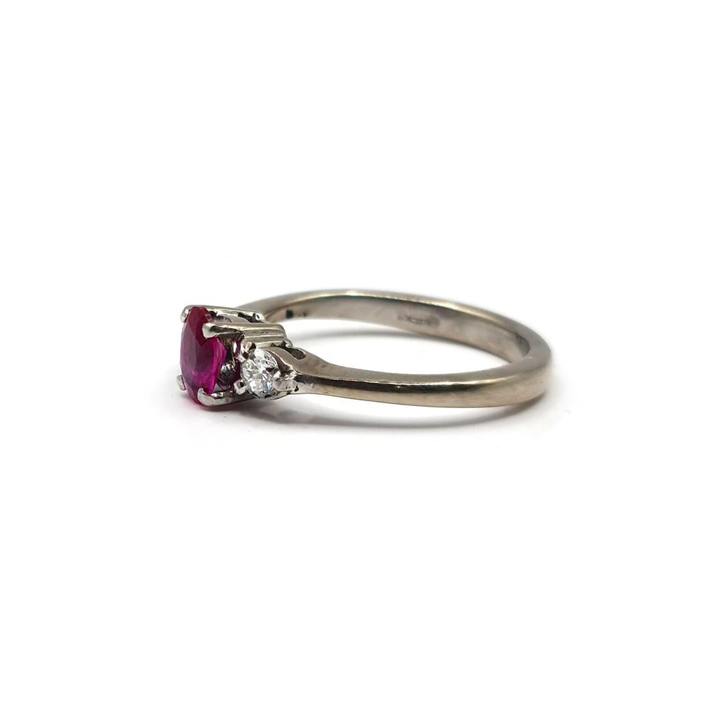 18ct white gold ring with a 0.55 carat ruby and 0.20 carat diamond accents, elegant jewelry piece with a polished finish.