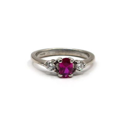 18ct white gold ring with a 0.55 carat ruby center stone and 0.20 carat diamonds, featuring a sleek, elegant design.