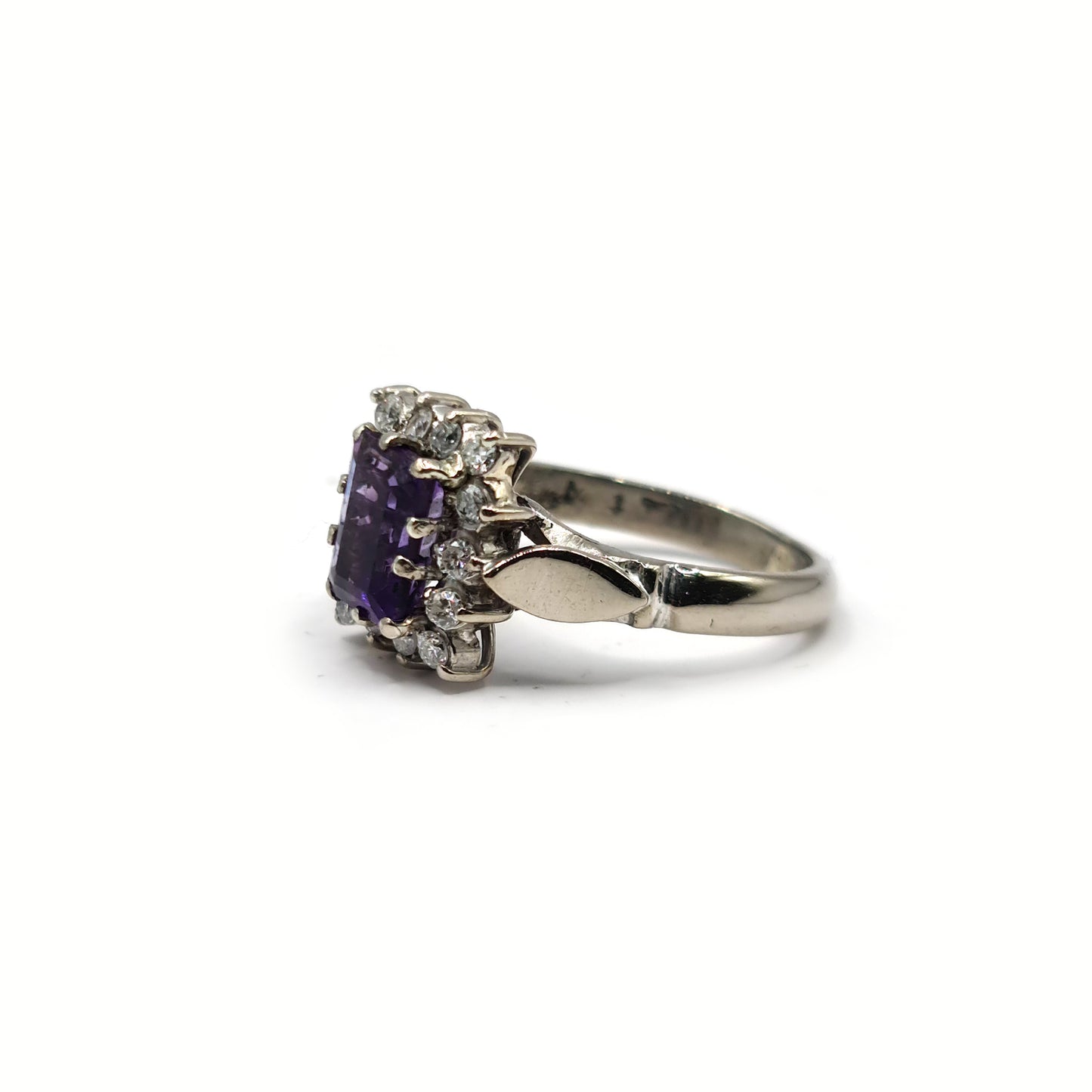 18ct white gold ring featuring a 1.05 carat emerald cut amethyst and 0.30 carat diamond accents.