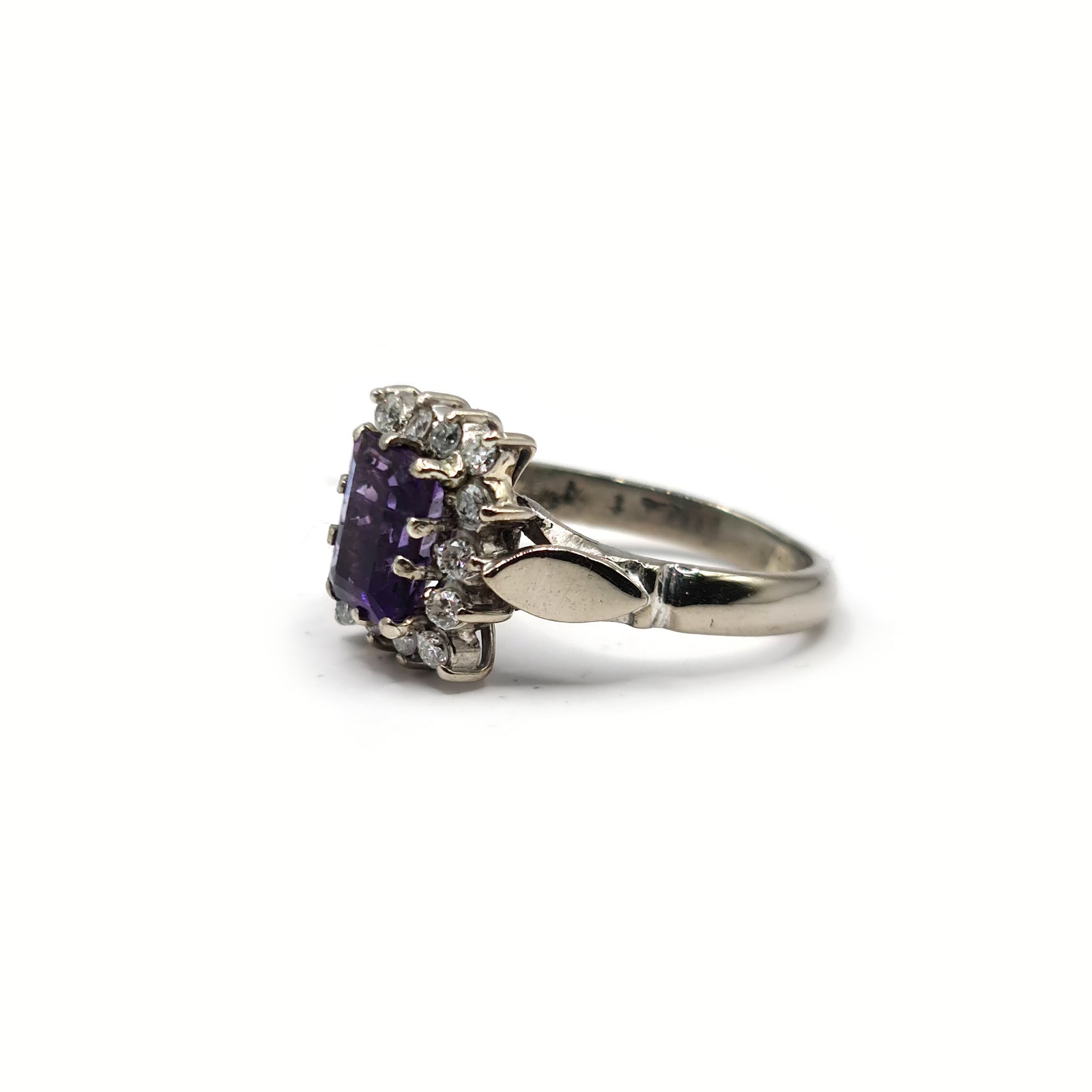 18ct white gold ring with a 1.05 carat emerald cut amethyst and 0.30 carat diamond accents, showcasing elegant gemstone details.