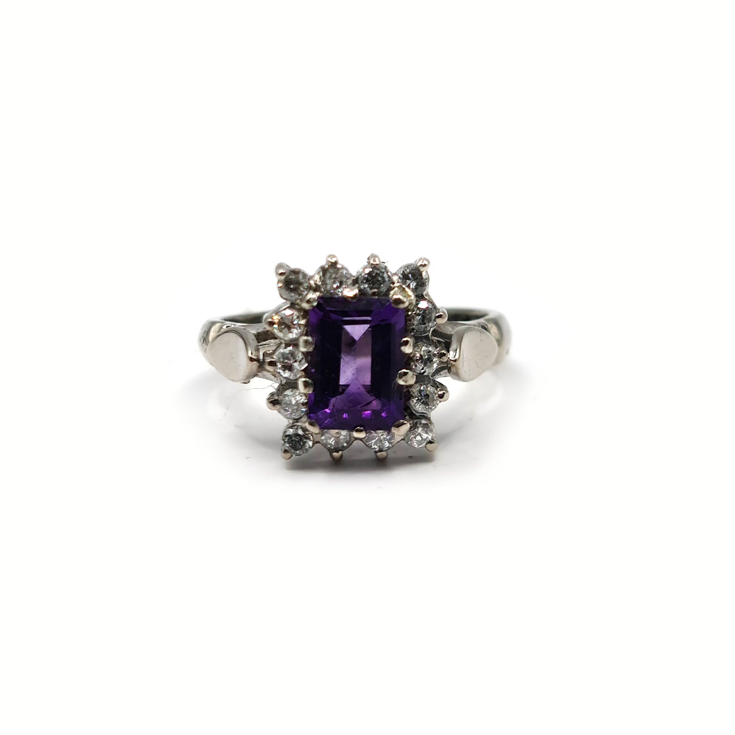 18ct white gold ring with a 1.05 carat emerald cut amethyst and 0.30 carat diamond accents, showcasing elegant jewelry design.